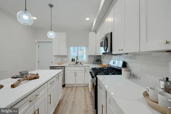 a kitchen with a sink a stove and cabinets