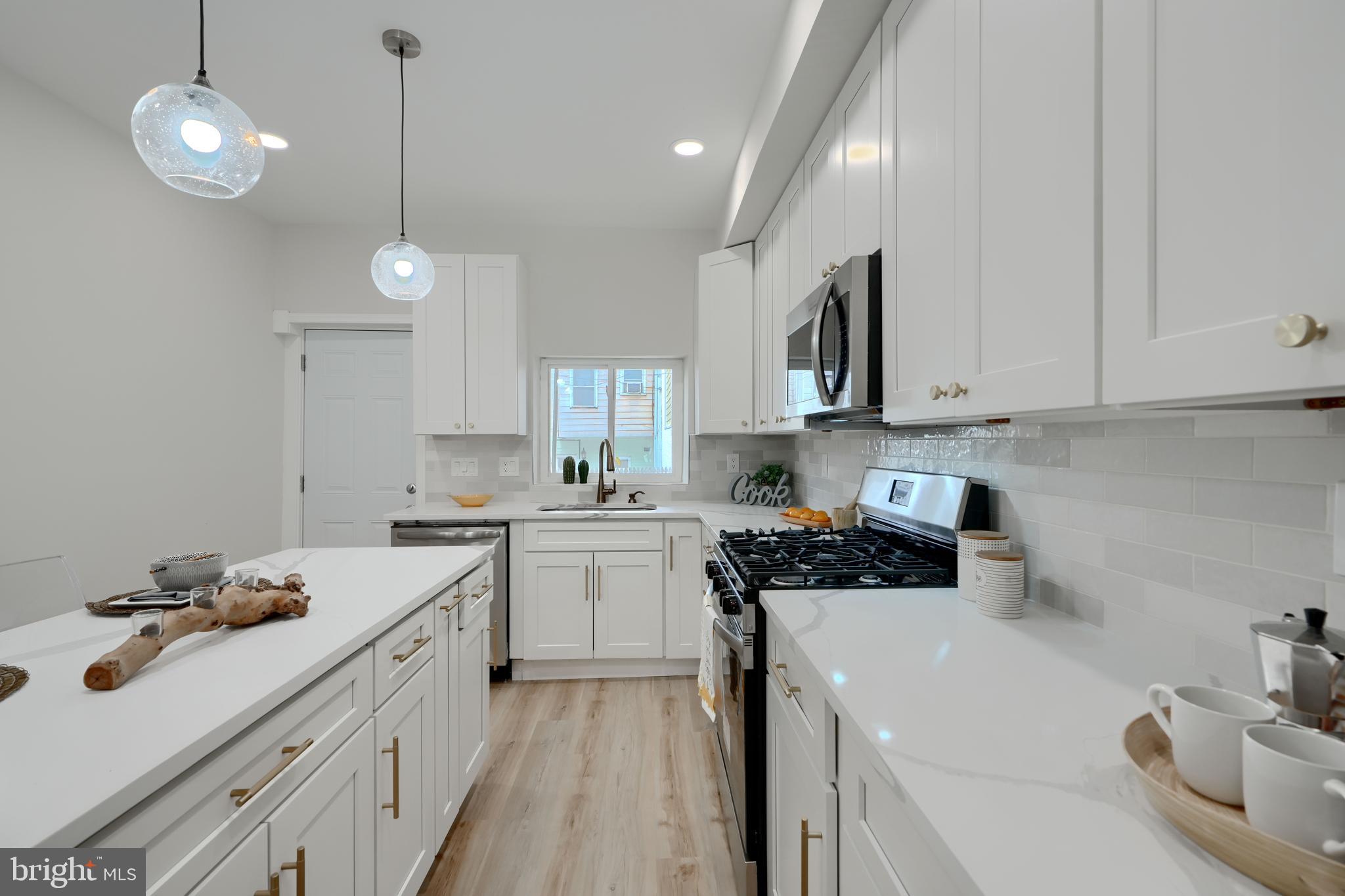 602 South Streeper Street Baltimore, MD 21224 - Photo 10 of 31 a kitchen with a sink a stove and cabinets