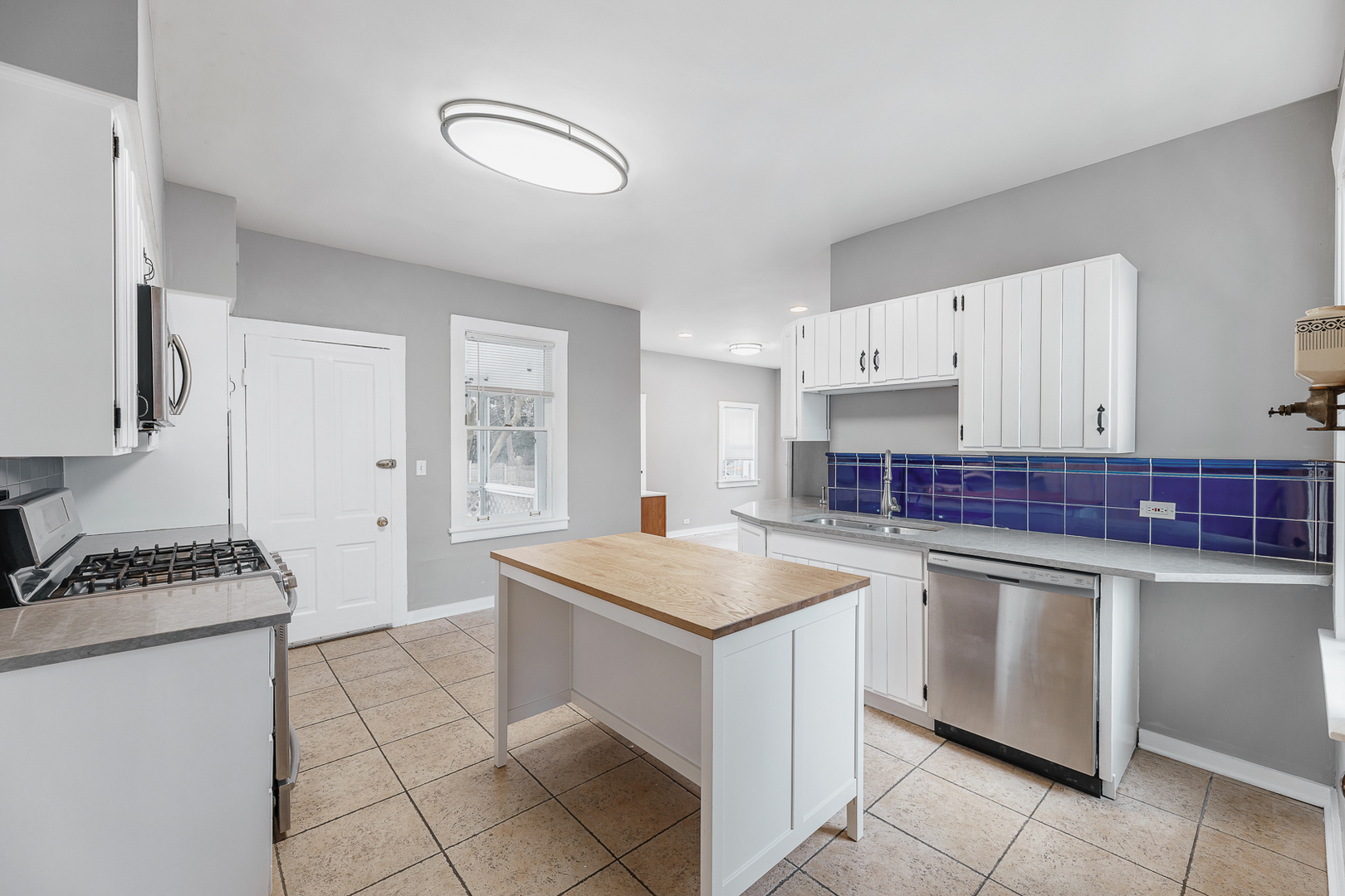 2404 Ridge Avenue Evanston, IL 60201 - Photo 5 of 24 a kitchen with granite countertop a sink stove and cabinets
