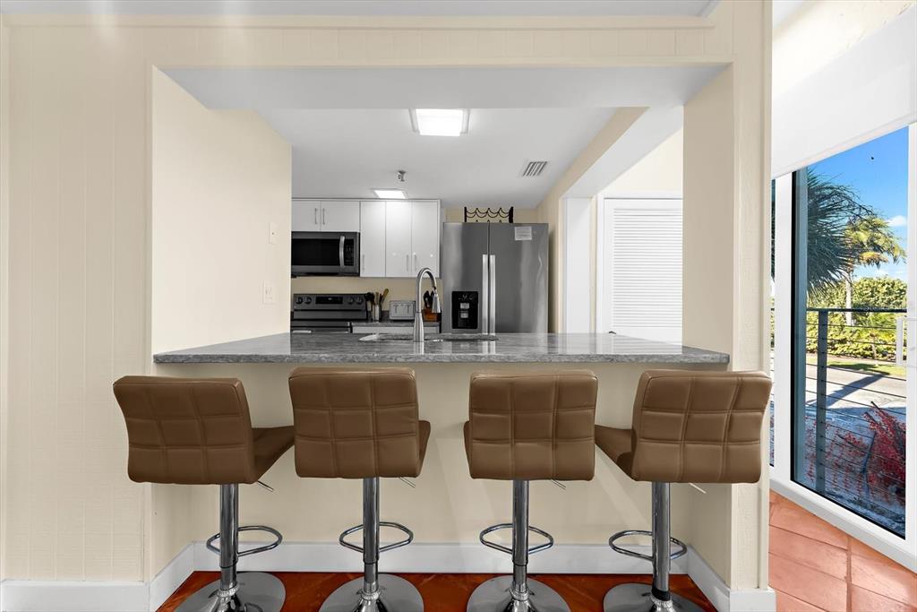 5000 Gasparilla Road, Unit 13A Boca Grande, FL 33921 - Photo 12 of 61 a living room with furniture and a flat screen tv