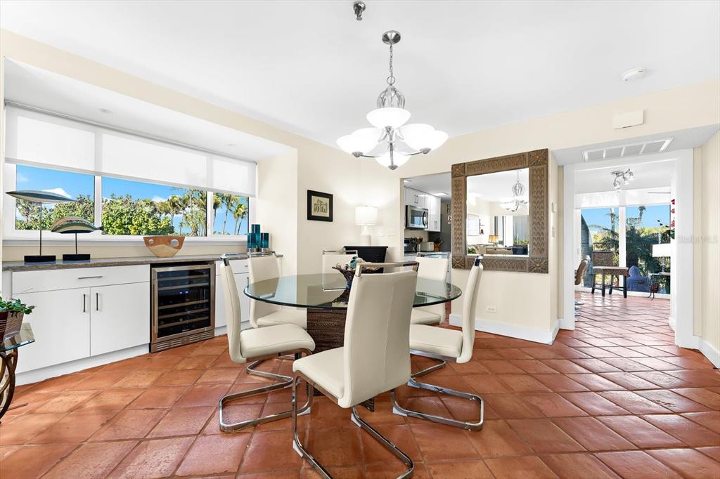 5000 Gasparilla Road, Unit 13A Boca Grande, FL 33921 - Photo 14 of 61 a view of a dining room and livingroom with furniture wooden floor a chandelier