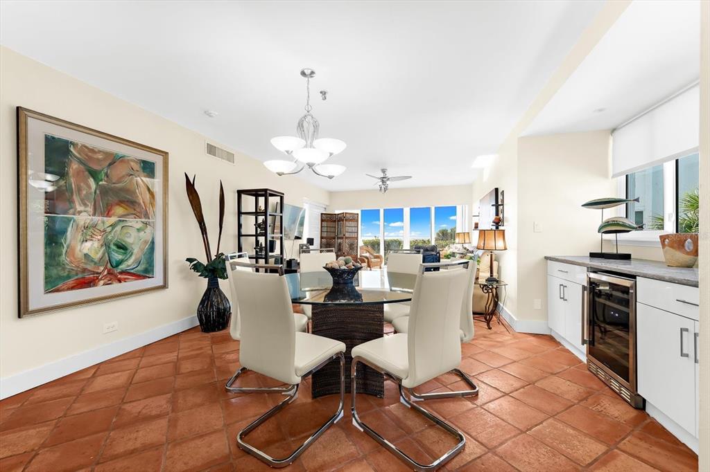 5000 Gasparilla Road, Unit 13A Boca Grande, FL 33921 - Photo 15 of 61 a view of a dining room with furniture a kitchen and chandelier