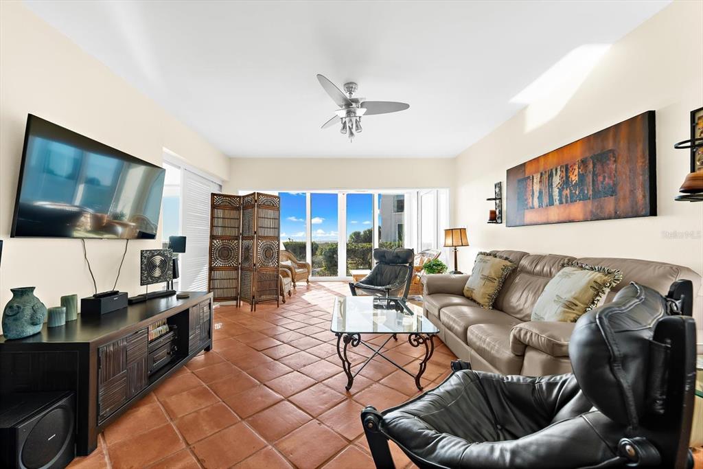 5000 Gasparilla Road, Unit 13A Boca Grande, FL 33921 - Photo 17 of 61 a living room with furniture and a flat screen tv