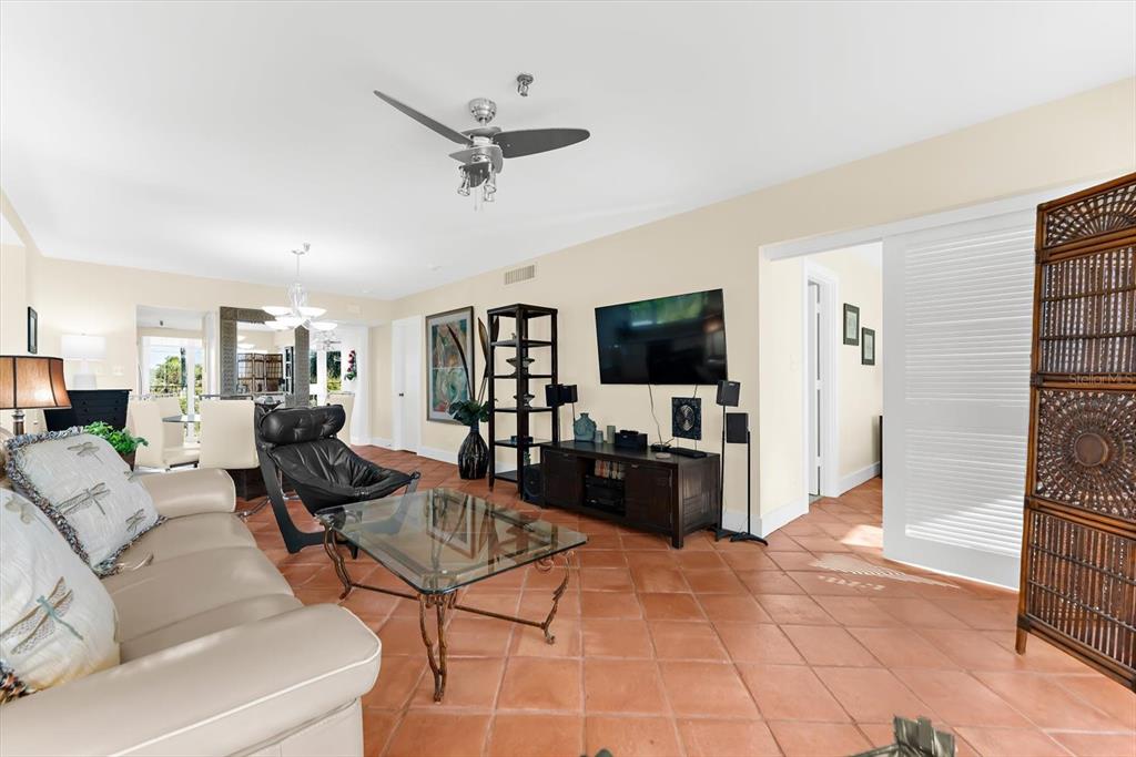 5000 Gasparilla Road, Unit 13A Boca Grande, FL 33921 - Photo 19 of 61 a living room with furniture and a flat screen tv