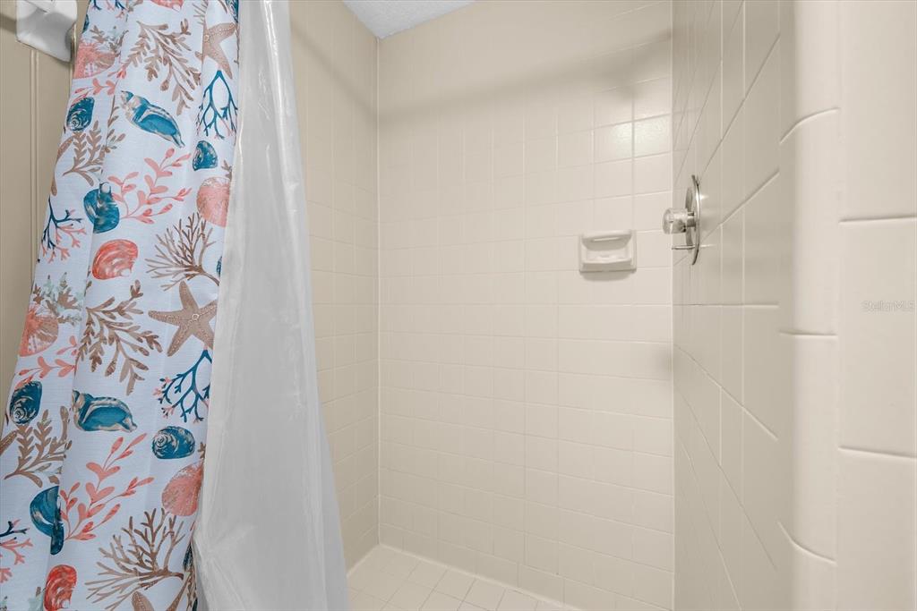 5000 Gasparilla Road, Unit 13A Boca Grande, FL 33921 - Photo 28 of 61 a bathroom with a shower curtain
