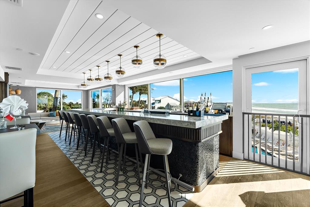 5000 Gasparilla Road, Unit 13A Boca Grande, FL 33921 - Photo 46 of 61 a dining hall with stainless steel appliances granite countertop a stove a sink a dining table and chairs with wooden floor