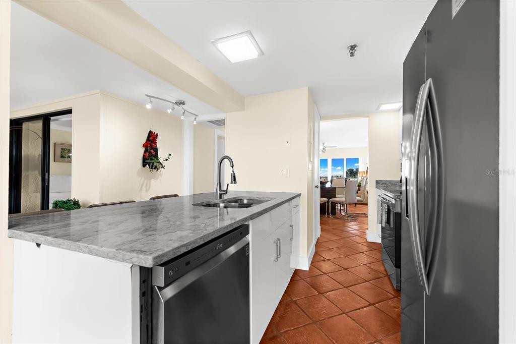 5000 Gasparilla Road, Unit 13A Boca Grande, FL 33921 - Photo 9 of 61 a kitchen with stainless steel appliances granite countertop a sink and a refrigerator