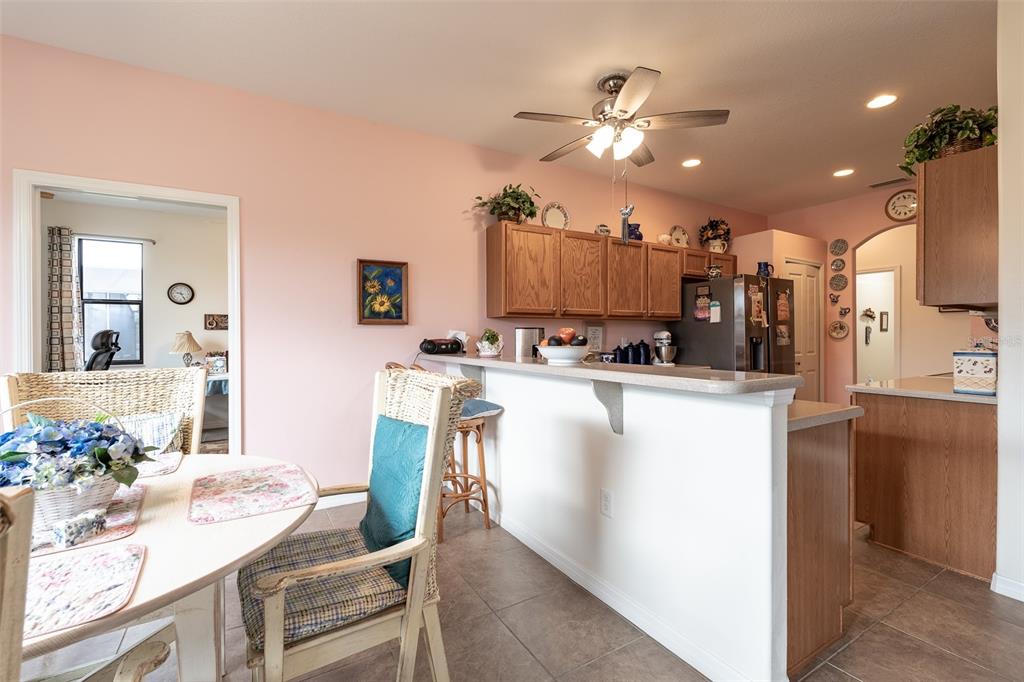 15969 Southwest 14th Avenue Road Ocala, FL 34473 - Photo 9 of 46 a dining room with kitchen island stainless steel appliances furniture a chandelier and a kitchen view