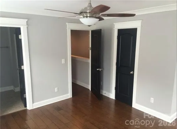 a view of a hallway with wooden floor