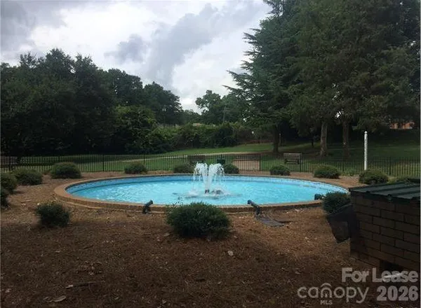 a view of a backyard with swimming pool