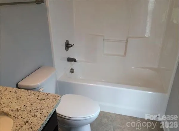 a bathroom with a toilet and a bathtub