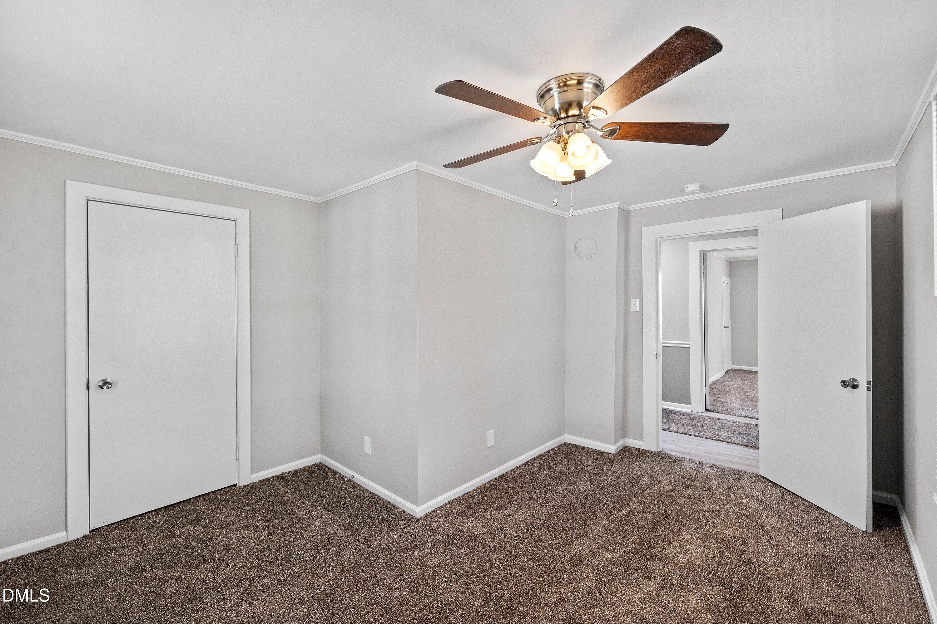 105 East I Street Erwin, NC 28339 - Photo 11 of 39 an empty room with closet and a ceiling fan
