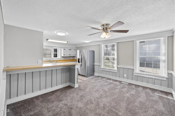 a large white kitchen with a window