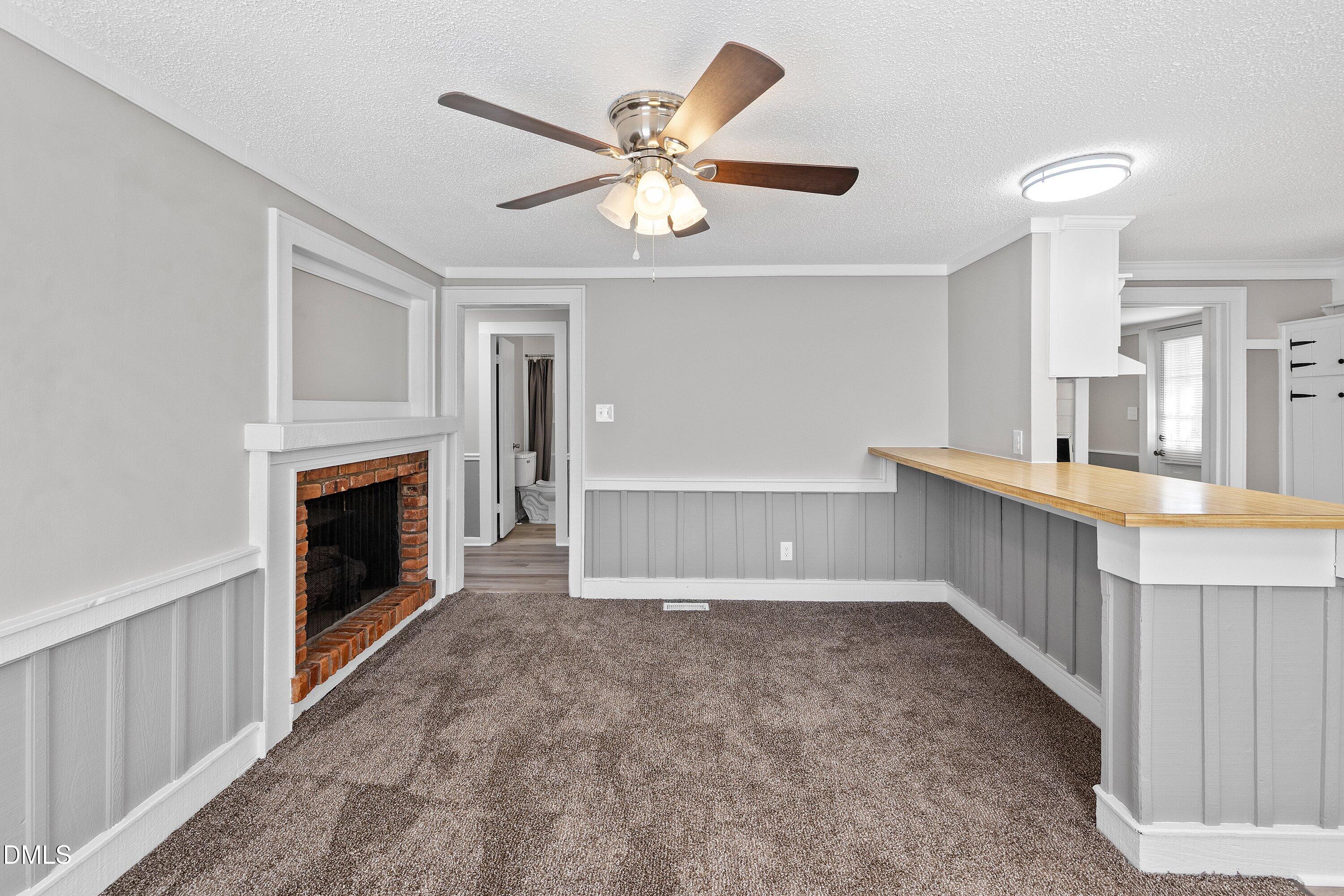 105 East I Street Erwin, NC 28339 - Photo 15 of 39 a view of an empty room with window and a kitchen