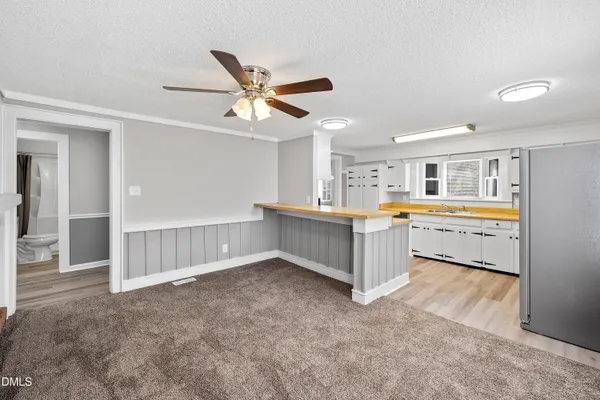 a large white kitchen with a lot of cabinets and a sink
