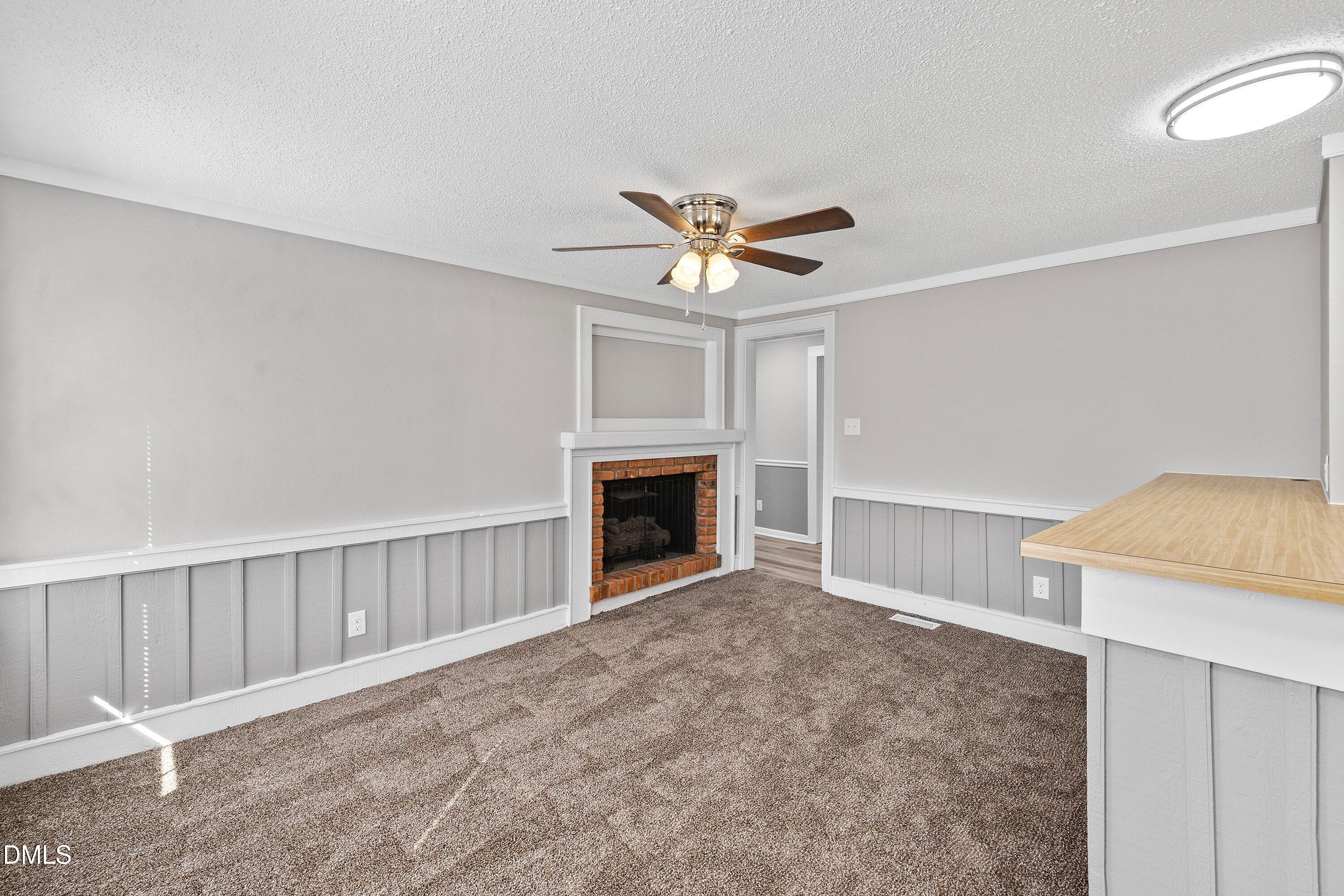105 East I Street Erwin, NC 28339 - Photo 17 of 39 a view of a livingroom with a fireplace and a chandelier fan