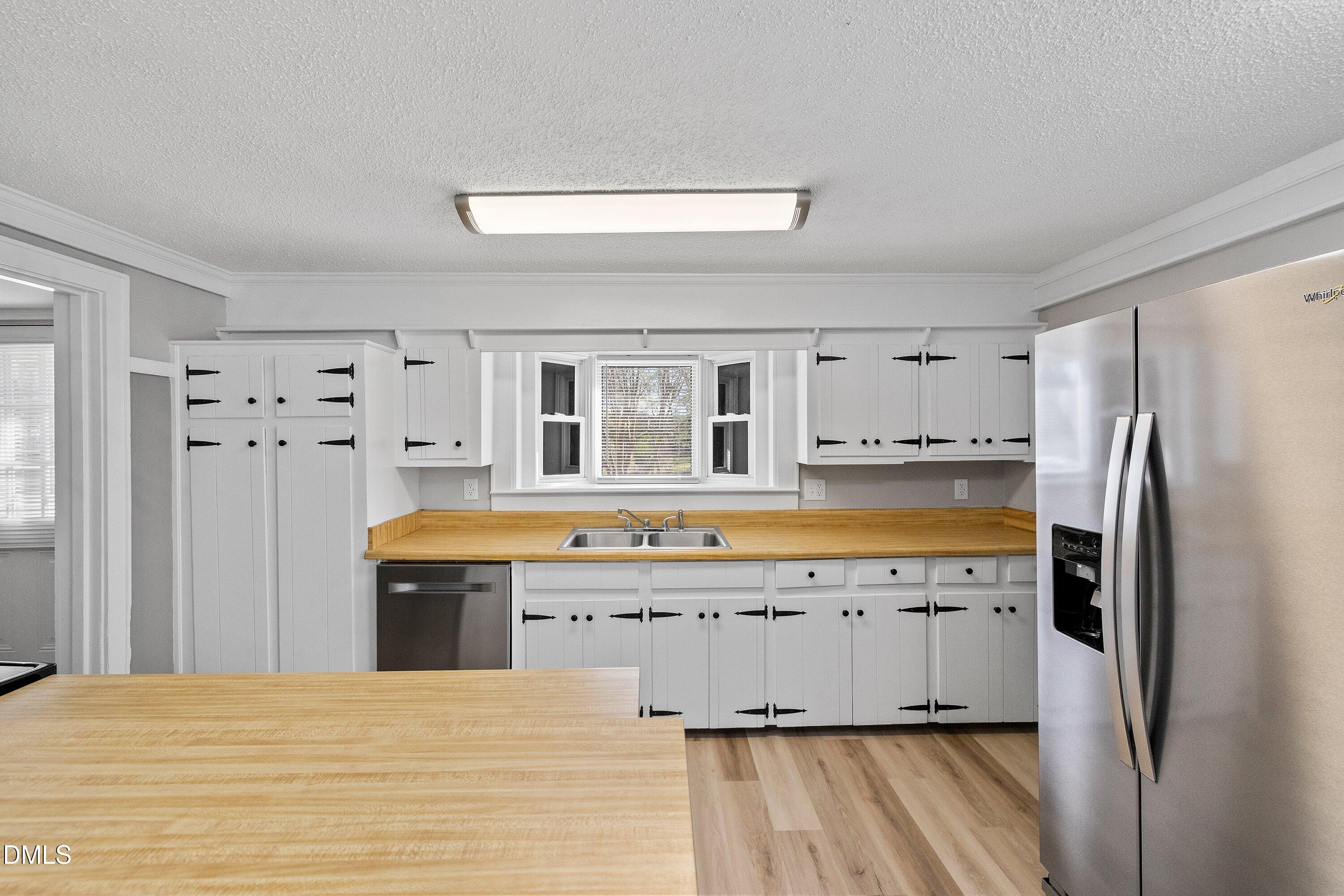 105 East I Street Erwin, NC 28339 - Photo 20 of 39 a kitchen with stainless steel appliances granite countertop a refrigerator and a sink