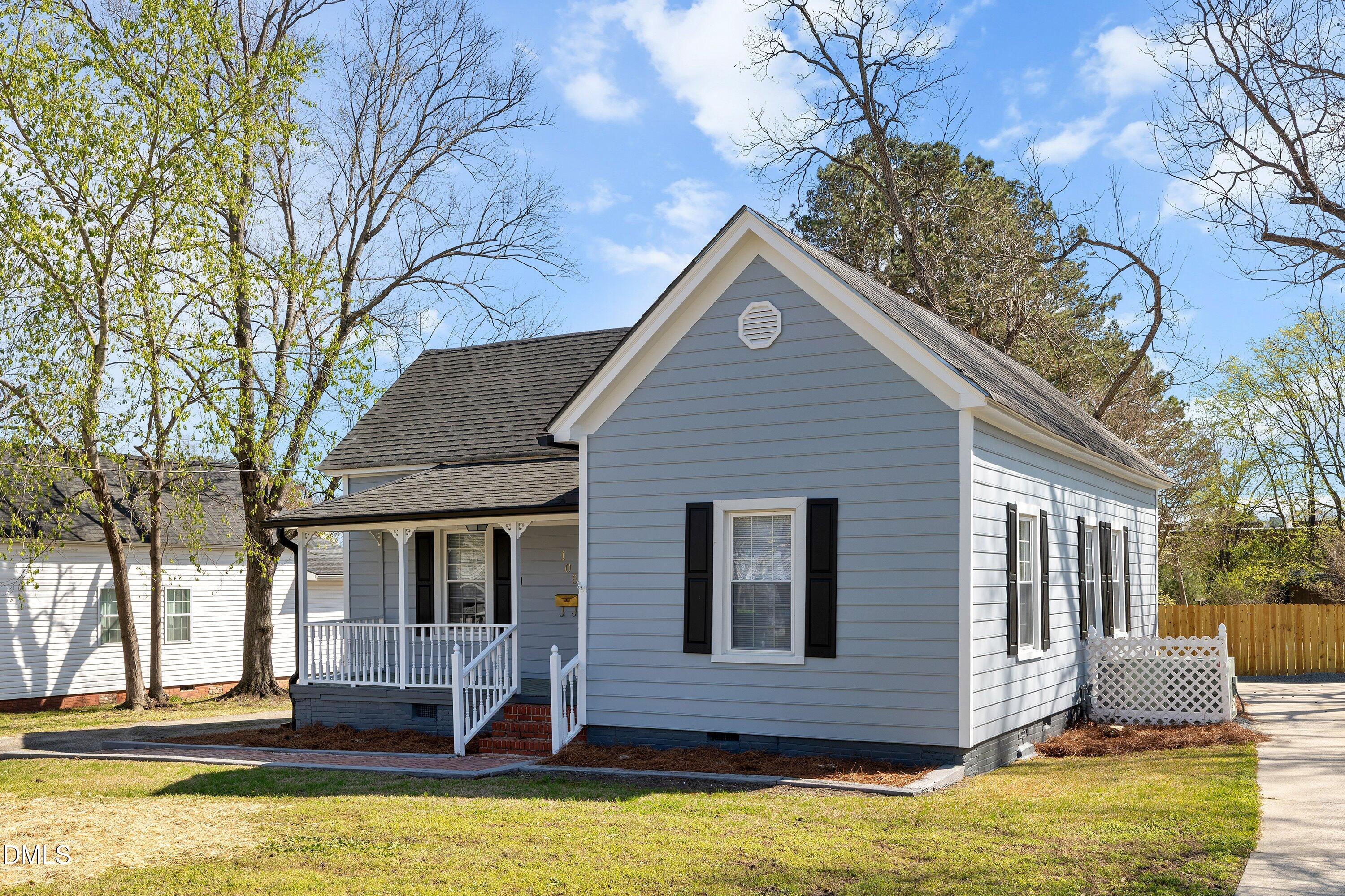 105 East I Street Erwin, NC 28339 - Photo 2 of 39 a view of a house with a yard patio and fire pit