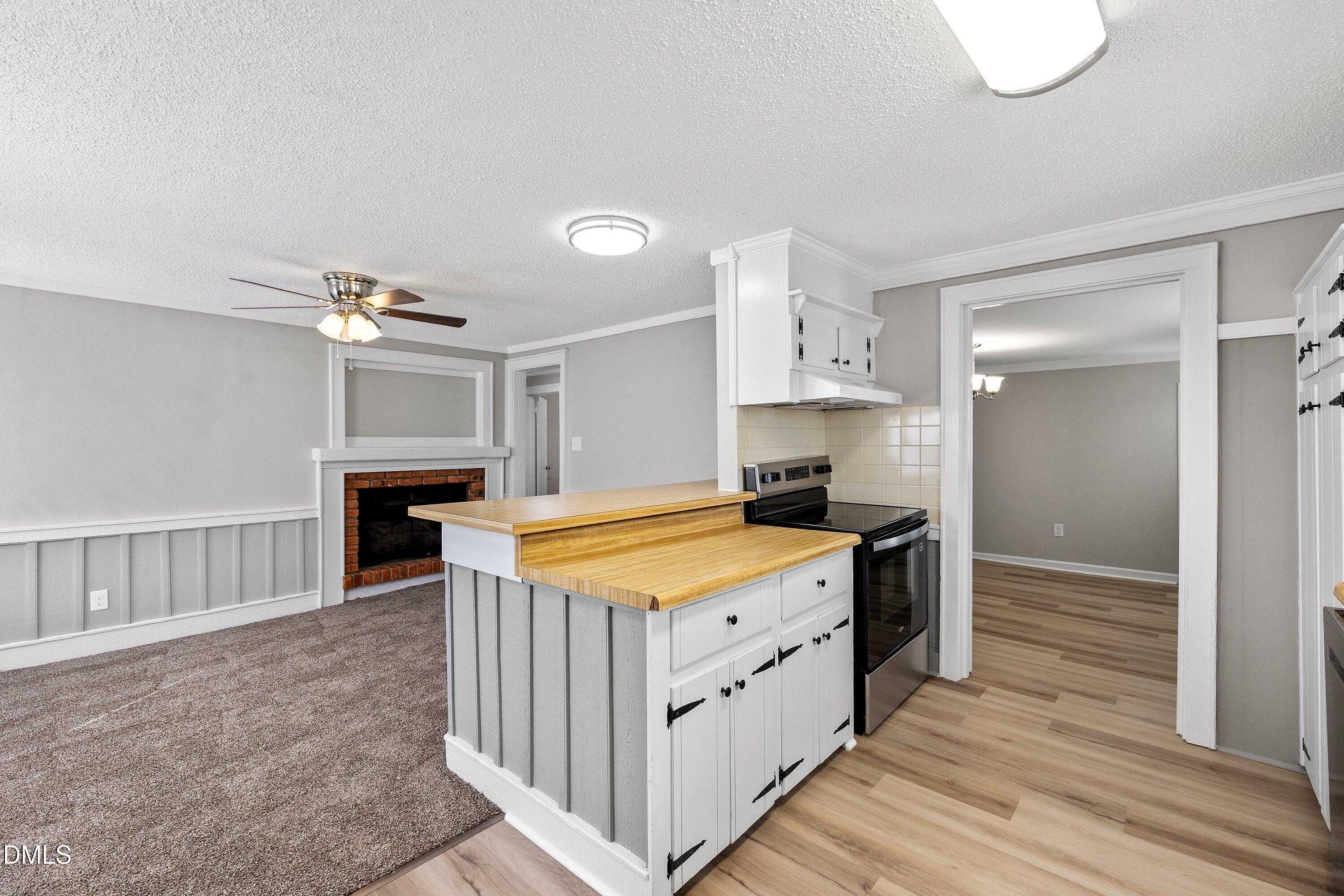 105 East I Street Erwin, NC 28339 - Photo 22 of 39 a kitchen that has a lot of cabinets in it and wooden floor