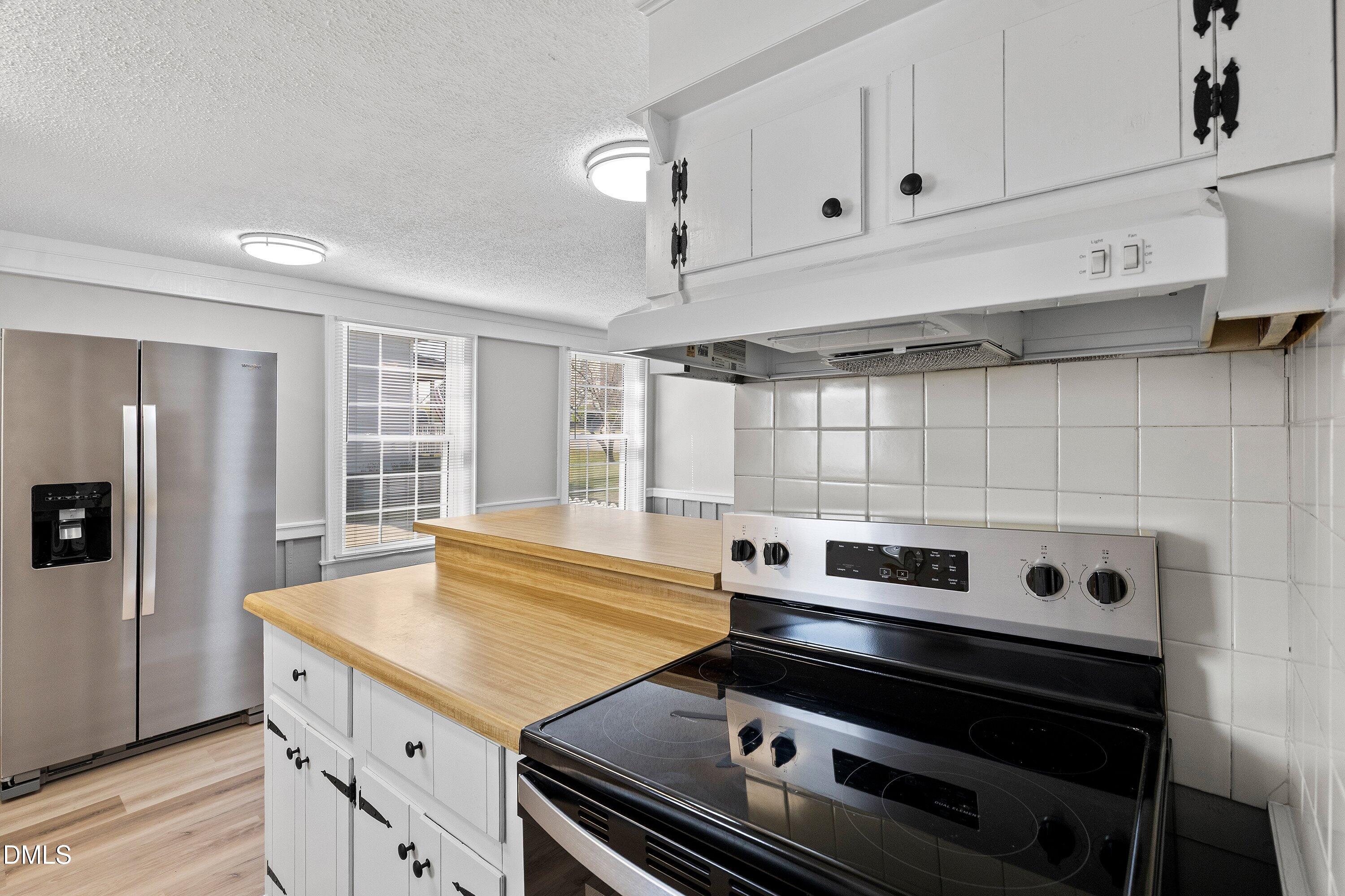 105 East I Street Erwin, NC 28339 - Photo 25 of 39 a stove top oven sitting inside of a kitchen