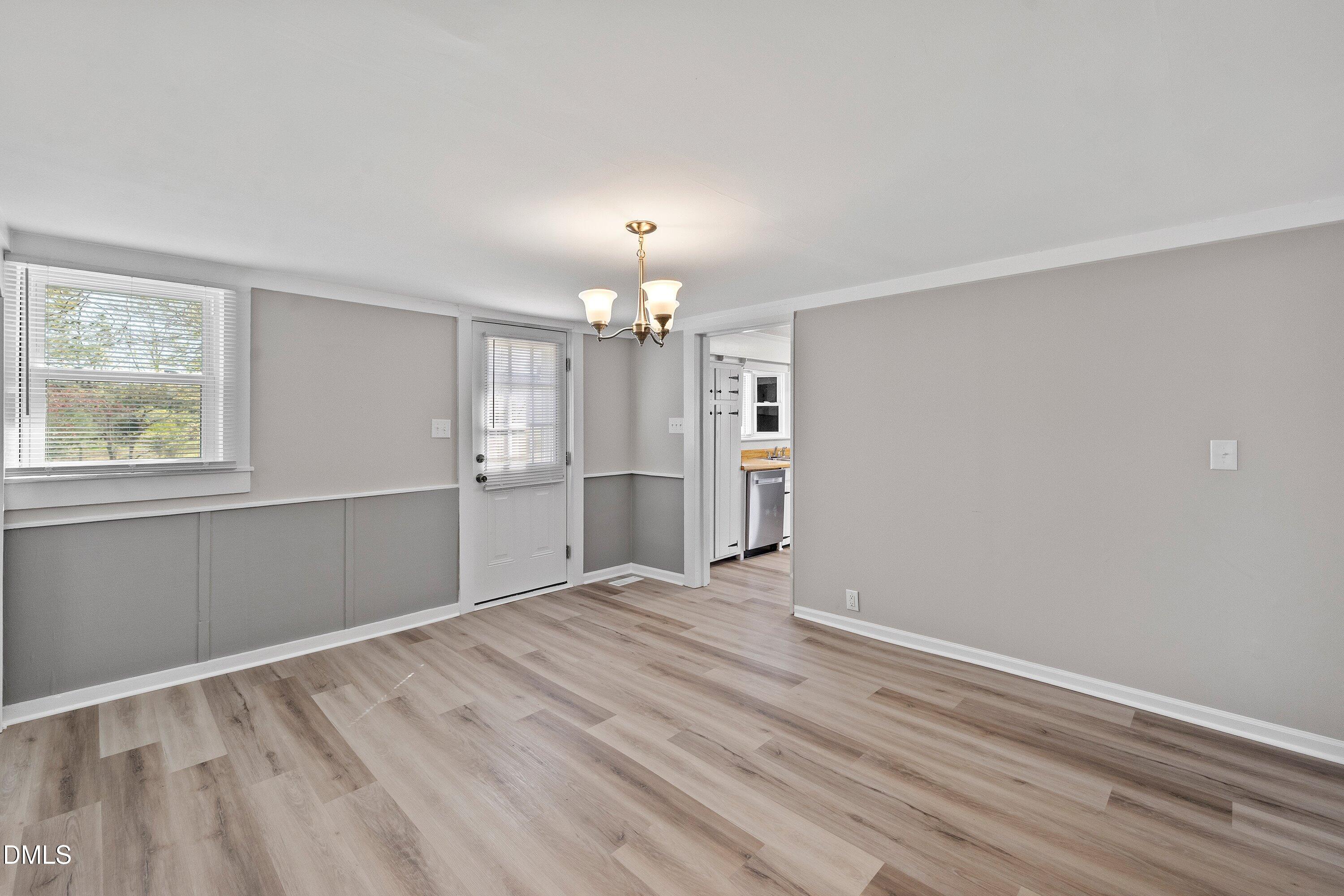 105 East I Street Erwin, NC 28339 - Photo 27 of 39 a view of empty room with wooden floor and window