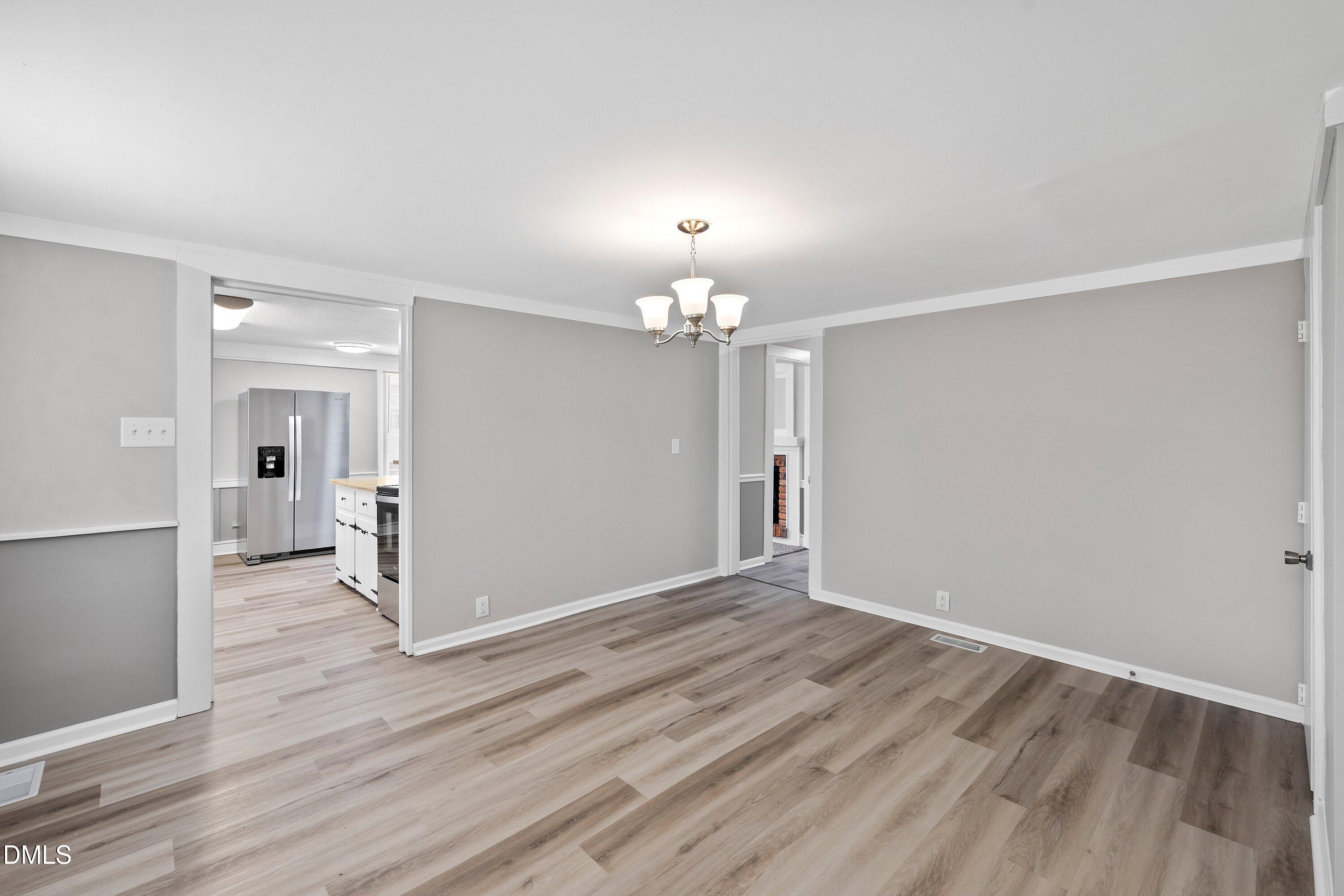 105 East I Street Erwin, NC 28339 - Photo 29 of 39 wooden floor in an empty room with a window