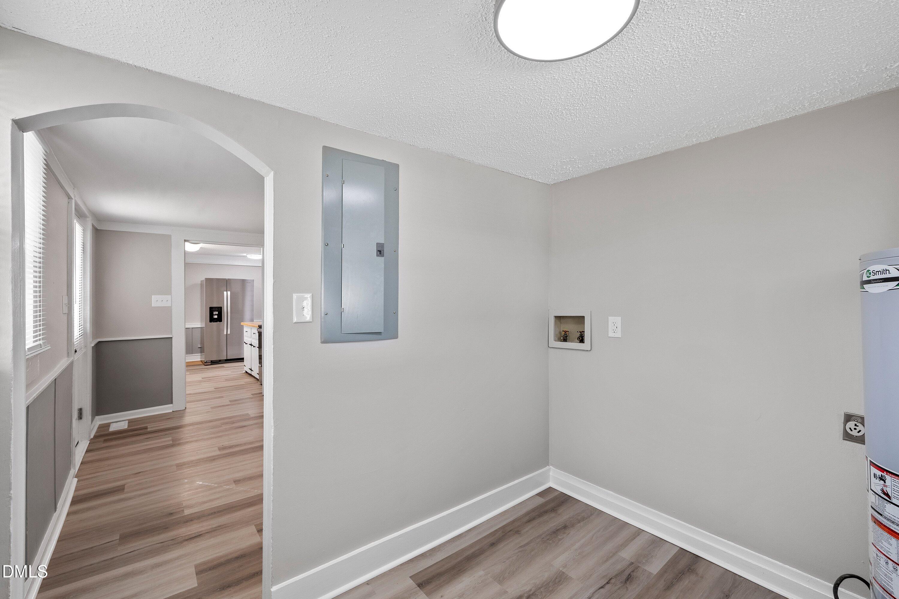 105 East I Street Erwin, NC 28339 - Photo 30 of 39 a view of a hallway with wooden floor and a bathroom