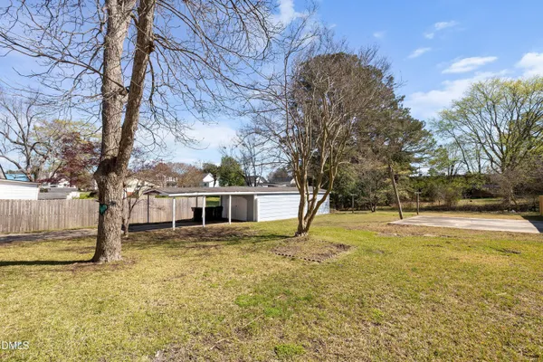 a view of a house with pool and trees