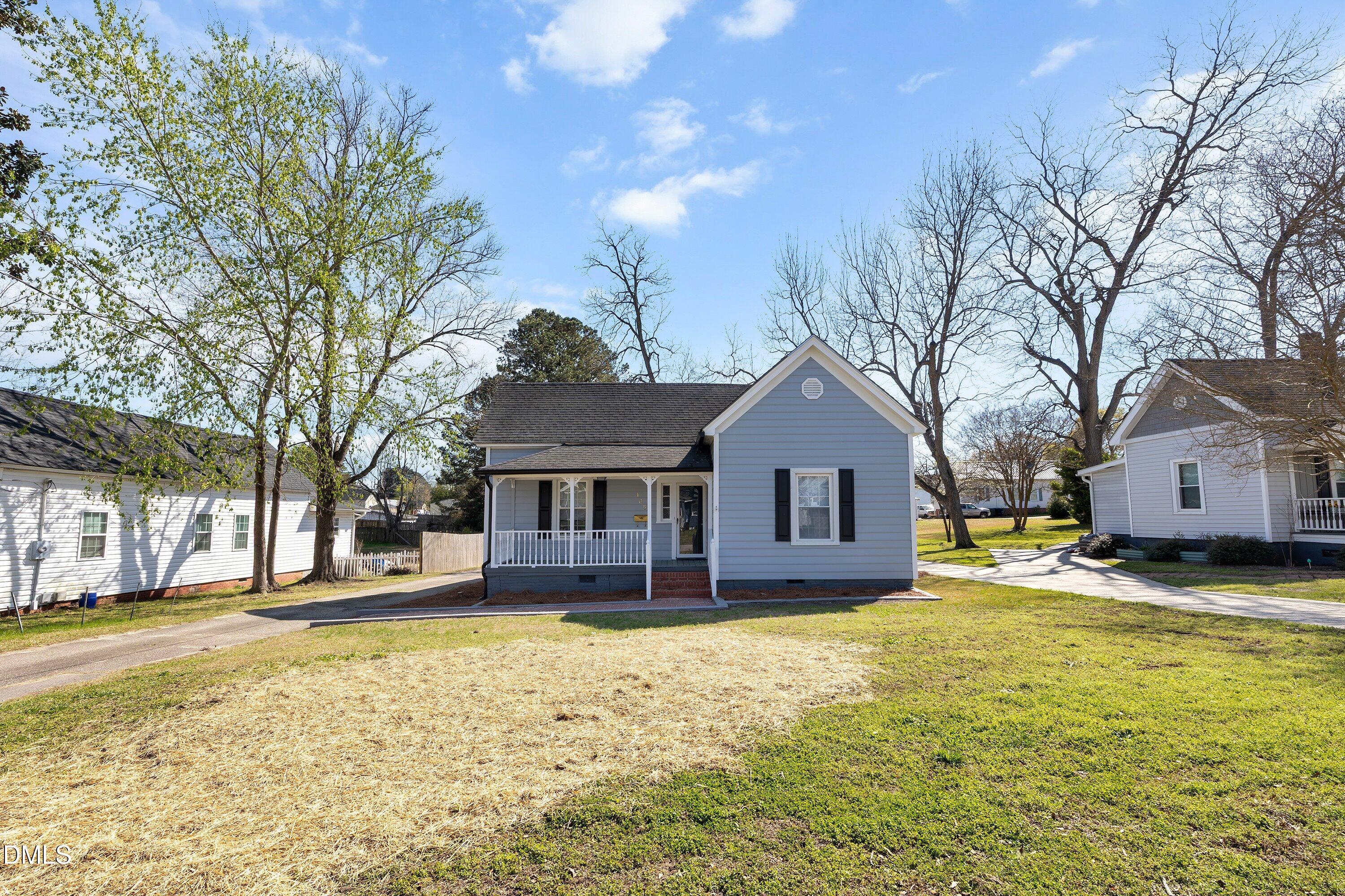 105 East I Street Erwin, NC 28339 - Photo 4 of 39 a view of a house with a yard covered with snow