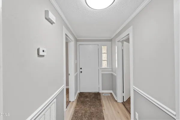 a view of a hallway with wooden floor and closet