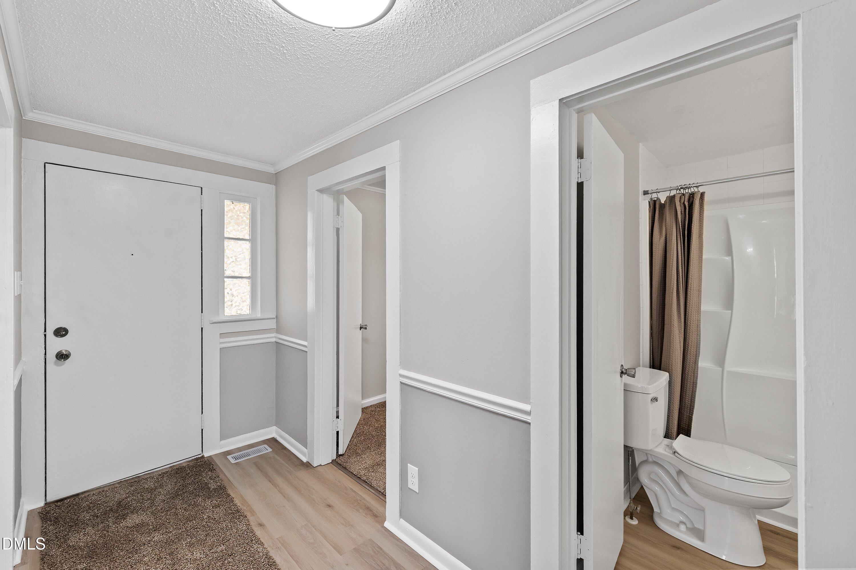 105 East I Street Erwin, NC 28339 - Photo 8 of 39 a bathroom with a granite countertop toilet a sink and shower