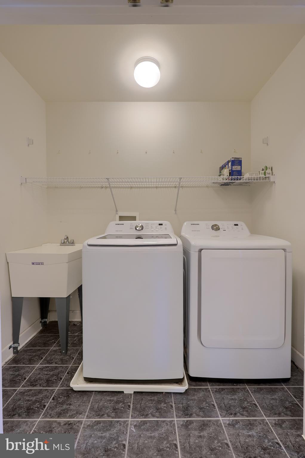 148 Michigan Drive Sinking Spring, PA 19608 - Photo 37 of 50 a utility room with a washer dryer and white cabinets
