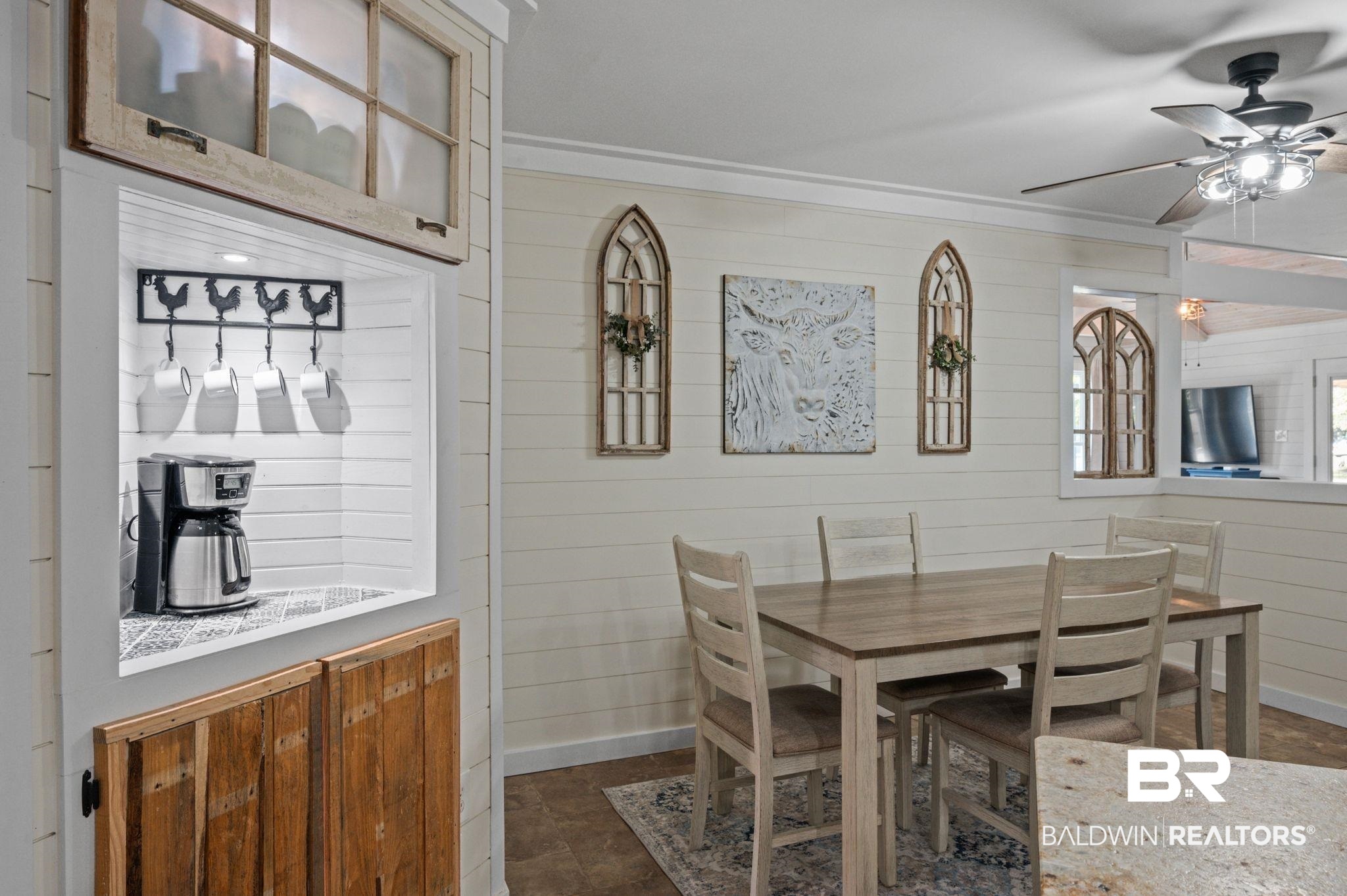 20037 County Road 33 Fairhope, AL 36532 - Photo 17 of 79 Dining space featuring crown molding, wooden walls, and ceiling fan