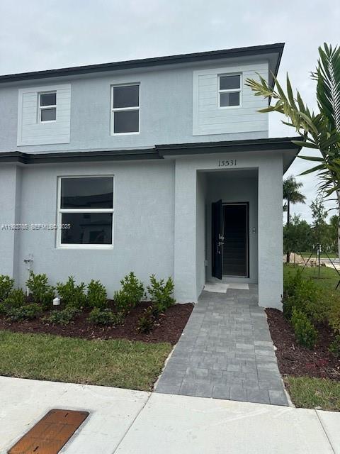 a front view of a house with garden