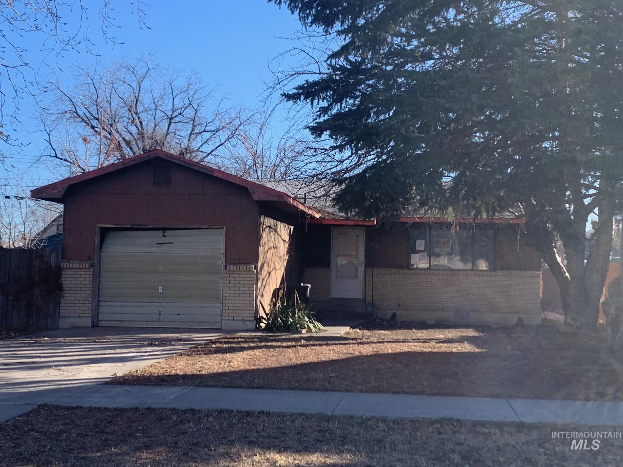 1435 Normal Burley, ID 83318 - Photo 2 of 9 Single story home with brick siding, driveway, and an attached garage