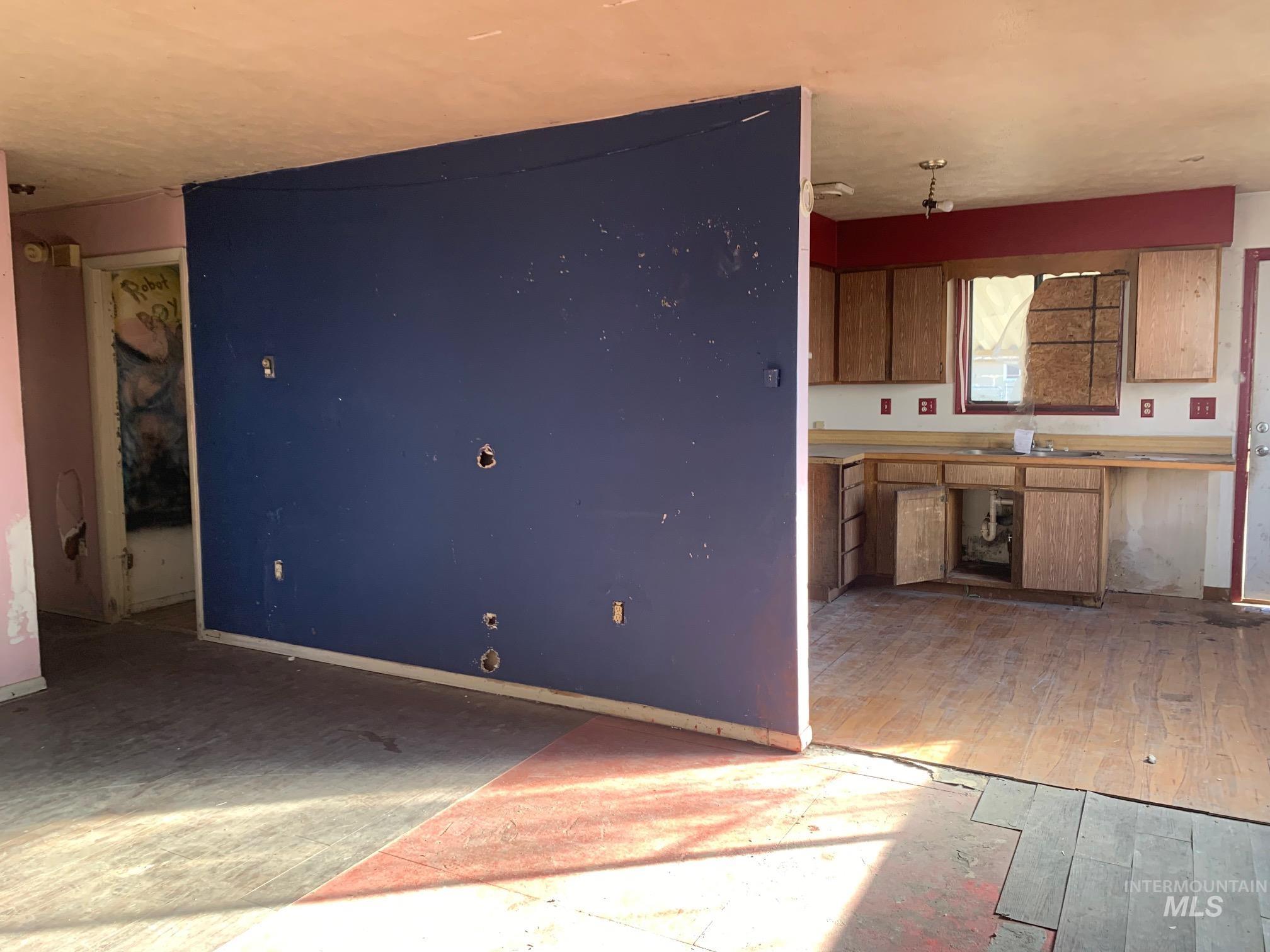 1435 Normal Burley, ID 83318 - Photo 5 of 9 Kitchen featuring brown cabinets, light wood finished floors, and light countertops