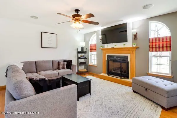 a living room with furniture a fireplace and a flat screen tv