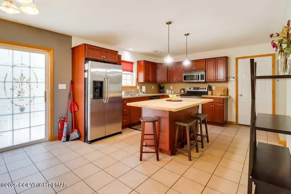 a kitchen with stainless steel appliances a stove a sink refrigerator and a refrigerator