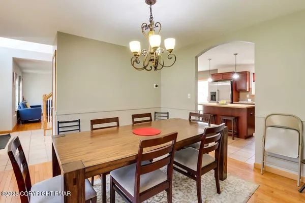 a view of a dining room with furniture and chandelier