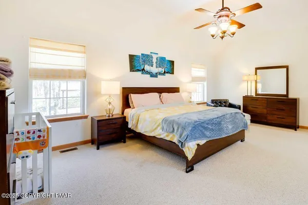 a bedroom with a bed dresser and a window