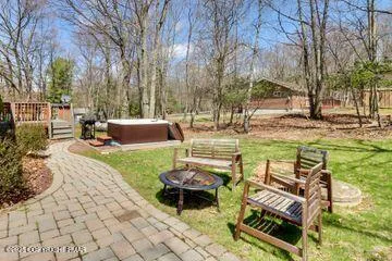 a view of a backyard with sitting area