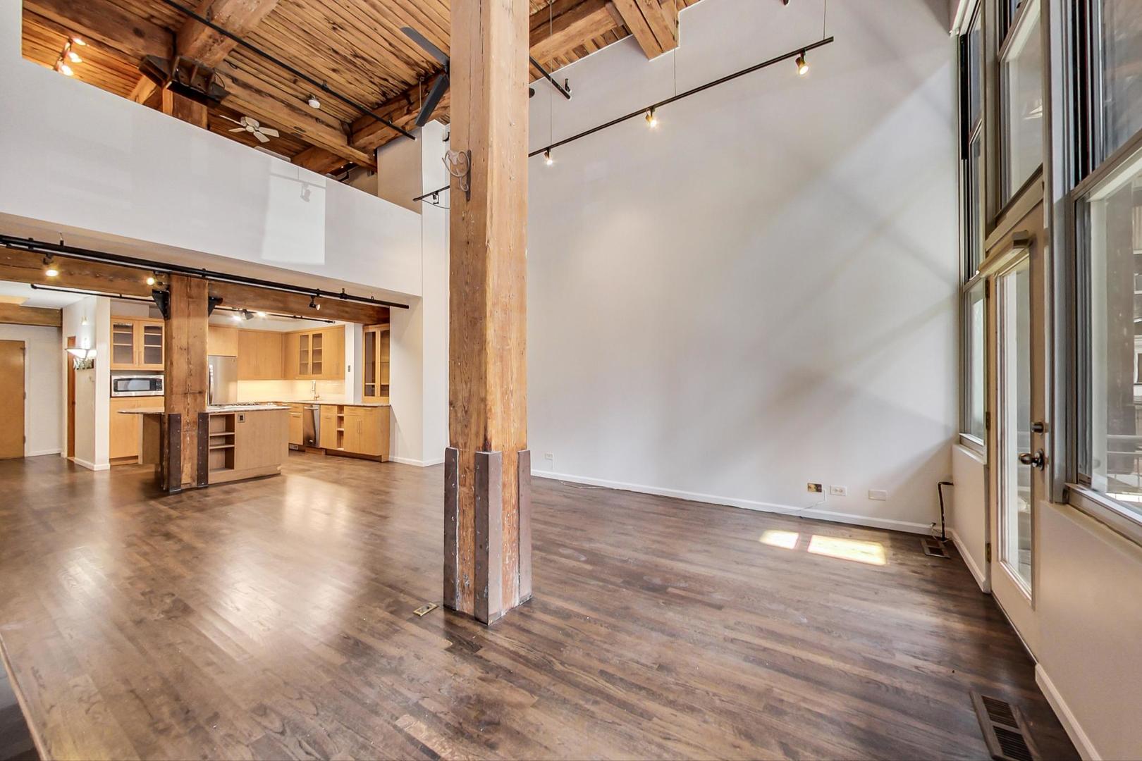 1000 West Washington Boulevard, Unit 130 Chicago, IL 60607 - Photo 14 of 47 a view of a hallway with wooden floor