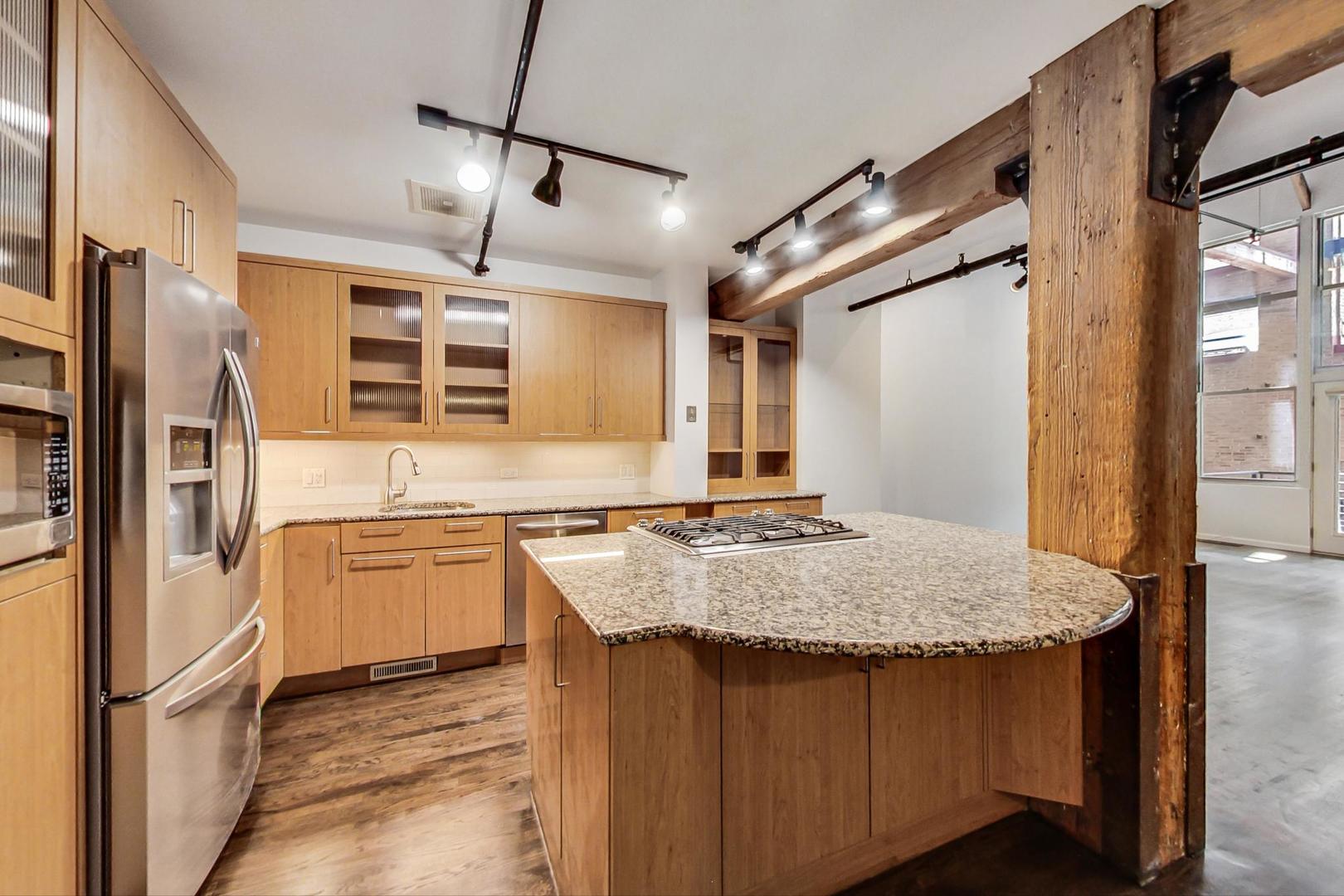 1000 West Washington Boulevard, Unit 130 Chicago, IL 60607 - Photo 15 of 47 a kitchen with stainless steel appliances granite countertop a sink stove and refrigerator