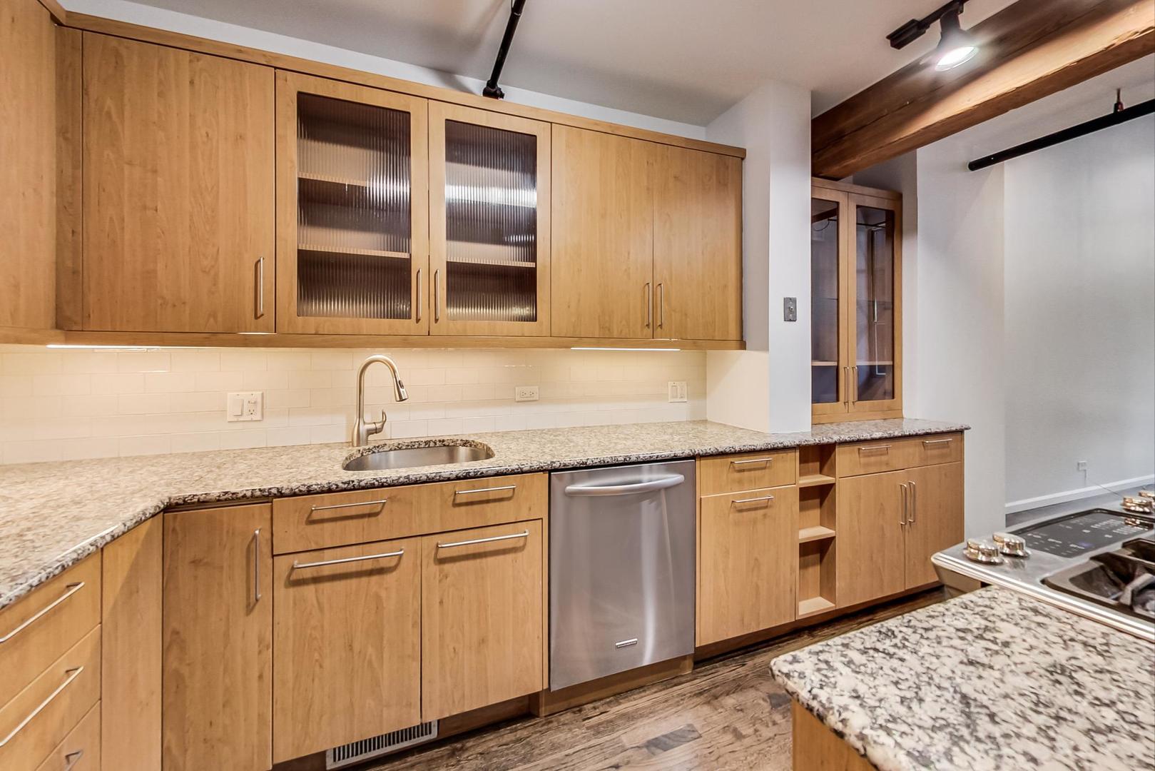1000 West Washington Boulevard, Unit 130 Chicago, IL 60607 - Photo 16 of 47 a kitchen with stainless steel appliances granite countertop a sink stove and cabinets