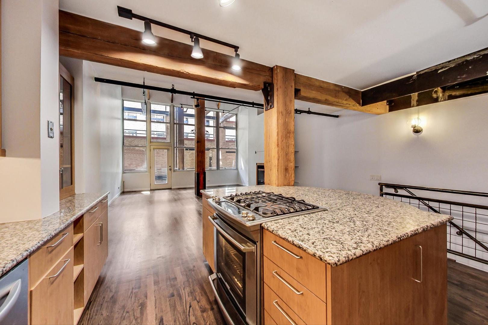 1000 West Washington Boulevard, Unit 130 Chicago, IL 60607 - Photo 17 of 47 a kitchen that has a stove and a table in it