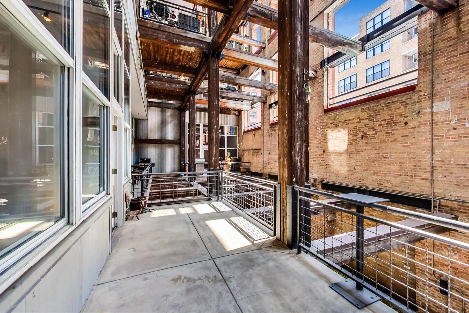 1000 West Washington Boulevard, Unit 130 Chicago, IL 60607 - Photo 21 of 47 a view of a brick building with many windows