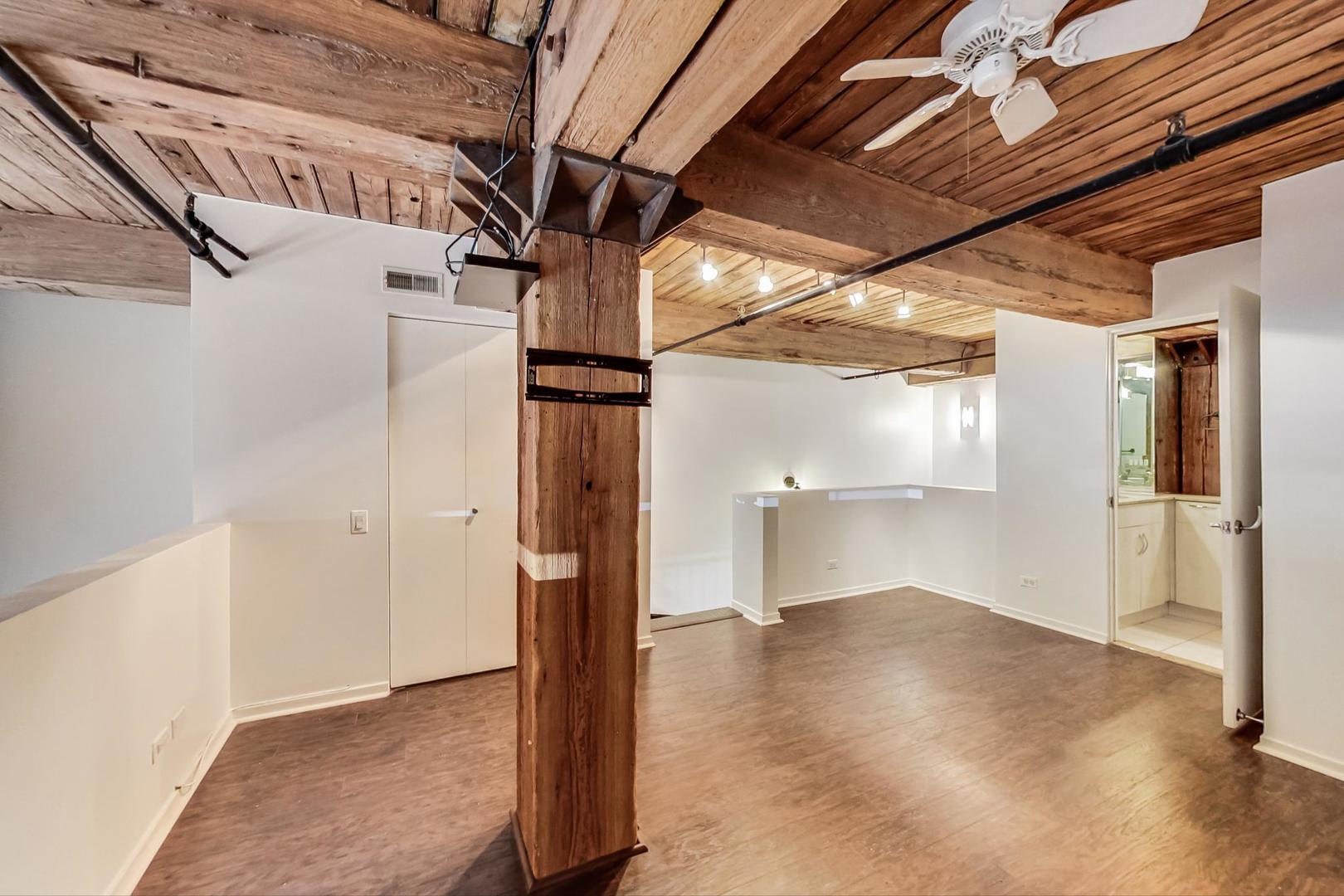 1000 West Washington Boulevard, Unit 130 Chicago, IL 60607 - Photo 24 of 47 a view of hallway with wooden floor