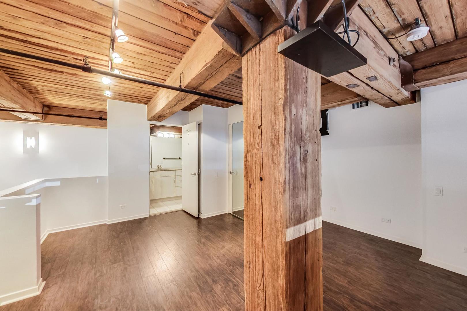 1000 West Washington Boulevard, Unit 130 Chicago, IL 60607 - Photo 26 of 47 a view of empty room with wooden floor