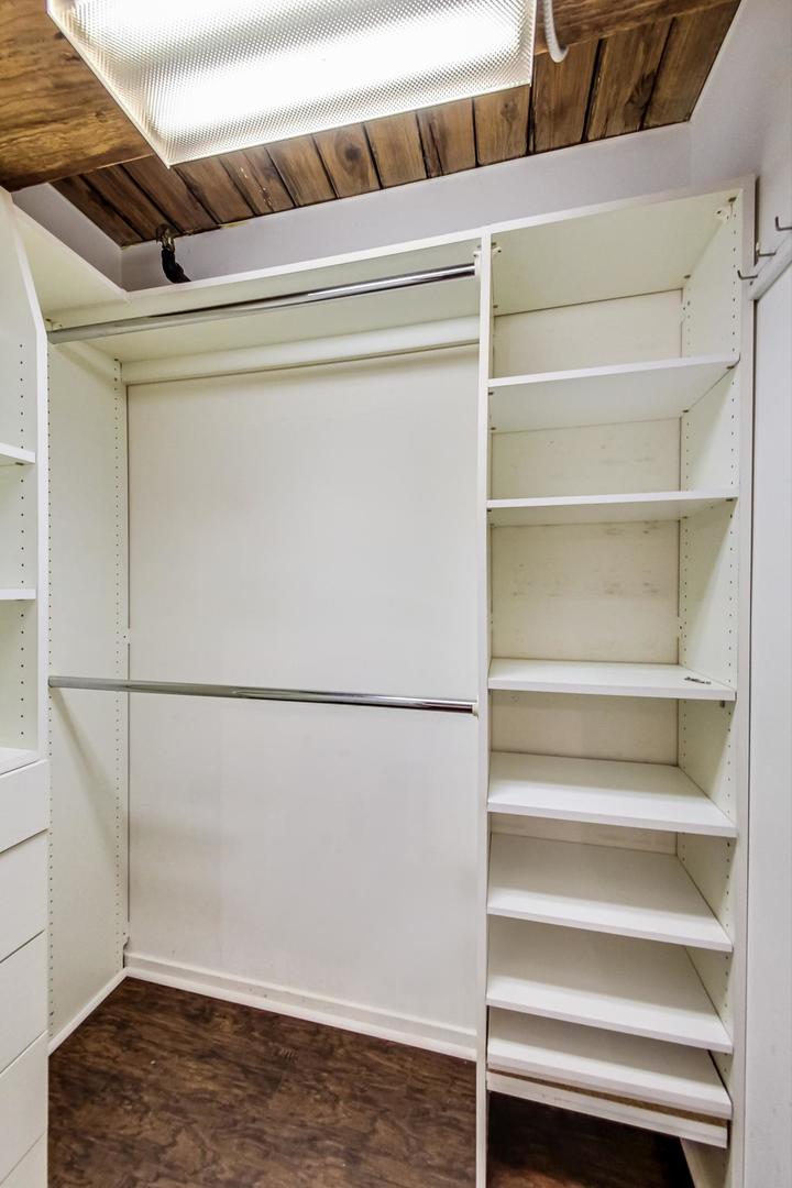 1000 West Washington Boulevard, Unit 130 Chicago, IL 60607 - Photo 28 of 47 a view of walk in closet with empty racks