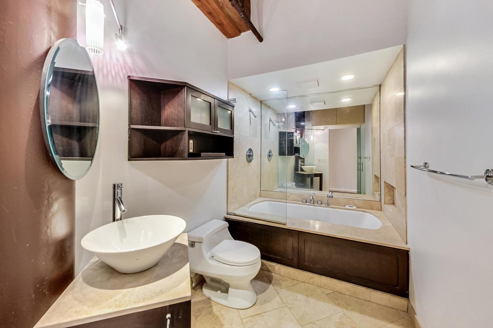 1000 West Washington Boulevard, Unit 130 Chicago, IL 60607 - Photo 36 of 47 a bathroom with a toilet sink and mirror